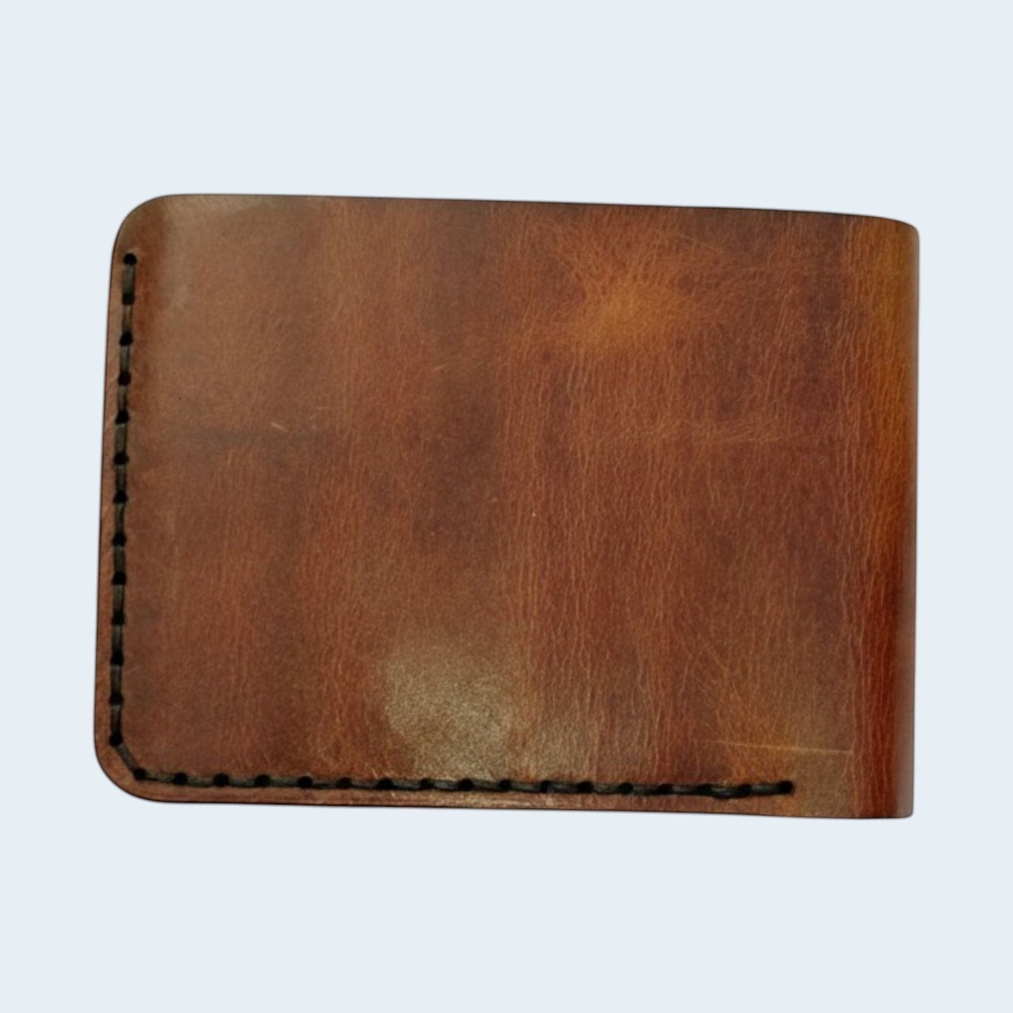 U&E Leather handcrafted brown bifold wallet with visible hand-stitched edges and premium genuine leather texture.